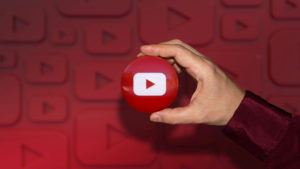 a hand holding a YouTube logo with YouTube background